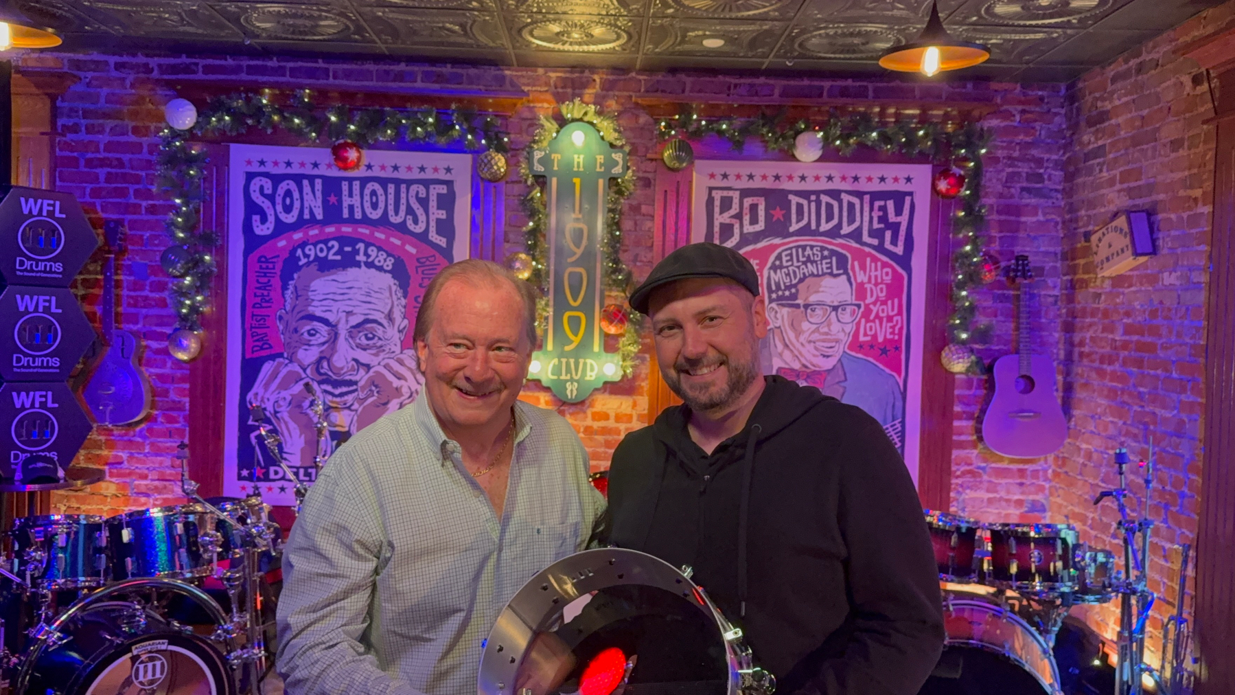 Bill Ludwig III and yours truly holding a snare drum in a jazz club.