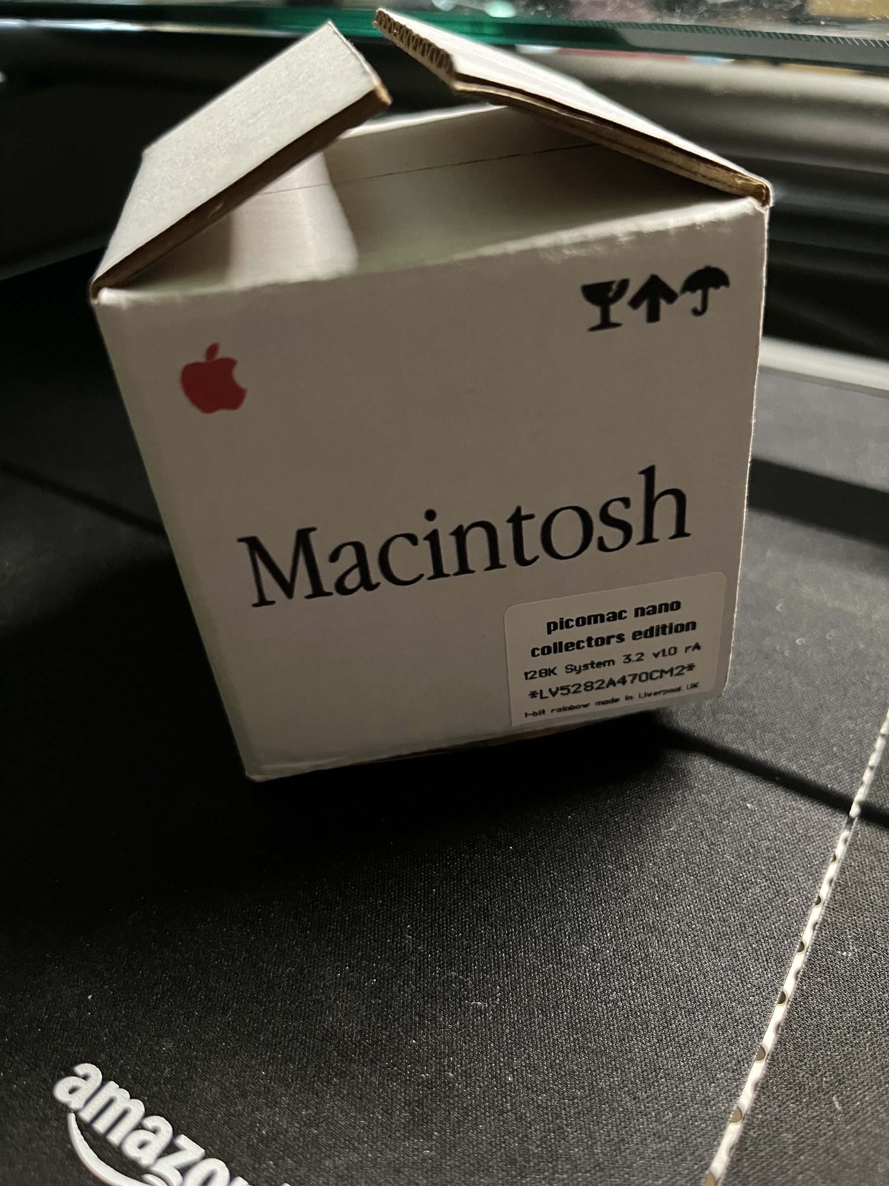 A small box labeled Macintosh with Apple branding and marked as a collector's edition is sitting on a surface.